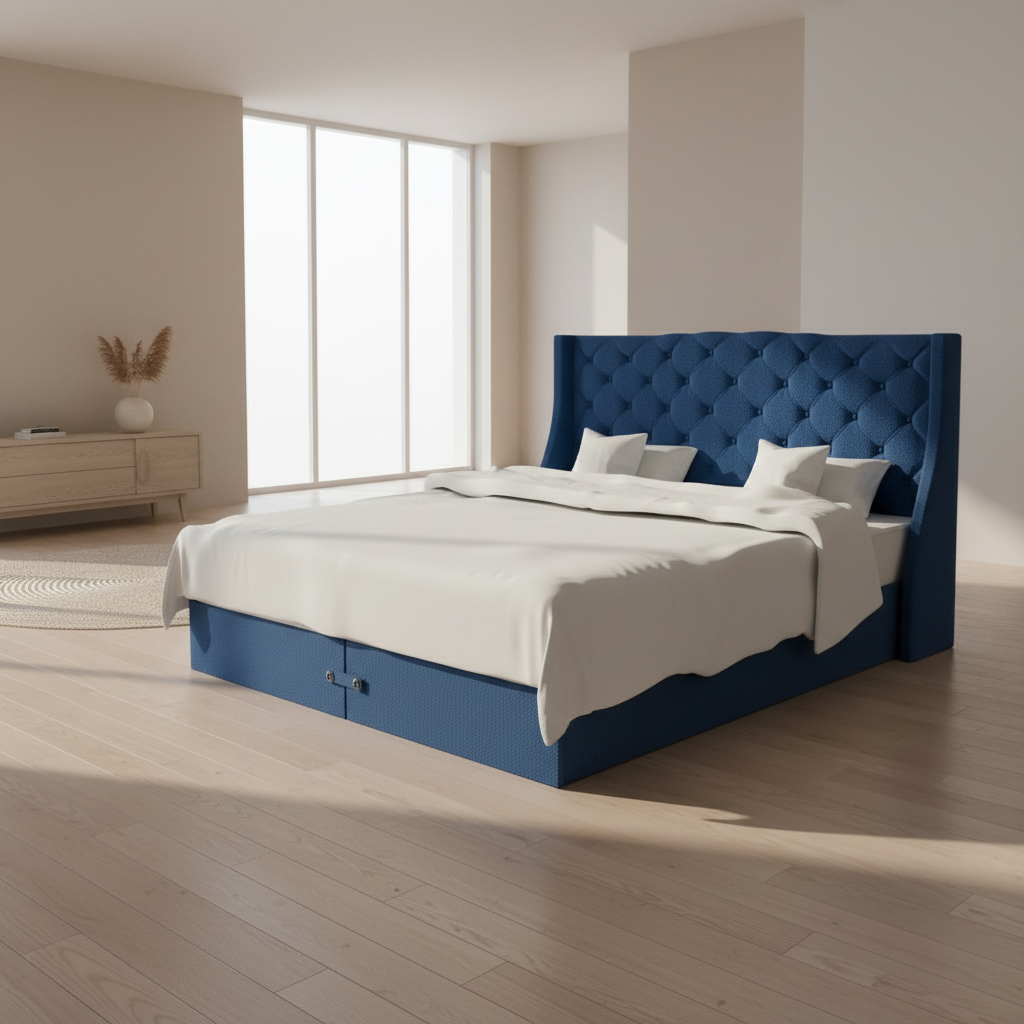 A blue upholstered wingback divan bed with white bedding, featuring a tufted chesterfield design.